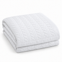 Hampton & Astley cotton quilted leaf-pattern bed throw in pure white, folded