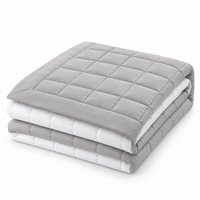 Hampton & Astley reversible cotton quilted bed throw in grey and white, folded